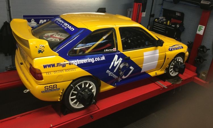 Escort Cosworth racing care on ramp for wheel alignment